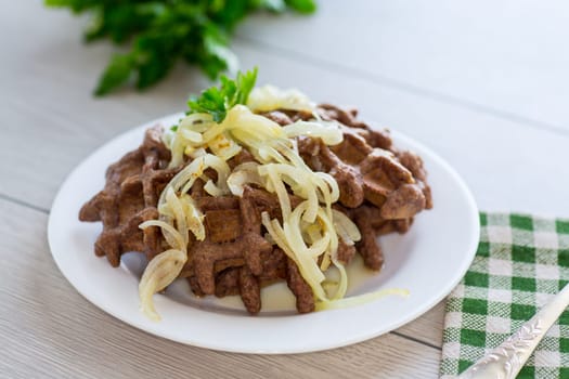 fried liver waffles with onions and herbs .