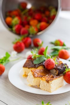 prepared cottage cheese casserole with fresh strawberries .