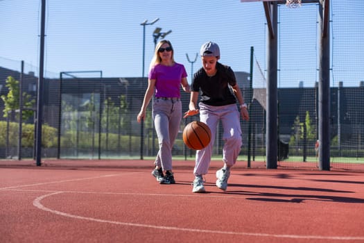 mother and daughter play basketball on a beautiful sunny day. High quality photo