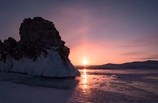 Ogoy island on winter Baikal lake. Winter scenery of Dragon Tail Rock on Ogoy island during sunrise at Lake Baikal.