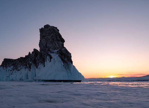 Ogoy island on winter Baikal lake. Winter scenery of Dragon Tail Rock on Ogoy island during sunrise at Lake Baikal.