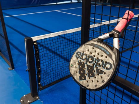 Ukraine Kyiv, May 23 2024. paddle tennis racket and balls on the blue paddle court. High quality photo