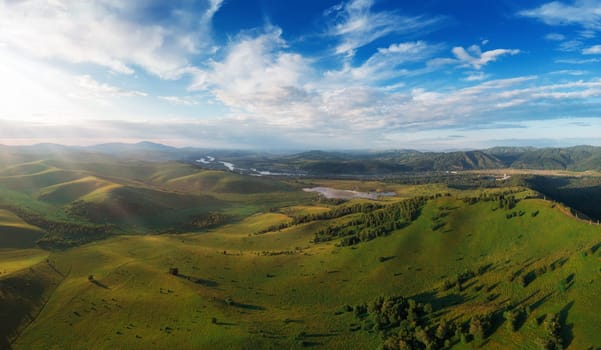 Aerial Panorama drone shot of beauty dawn on the peak, in the mountains in Altay, summertime