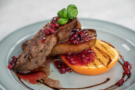 Tasty duck breast with orange and berries