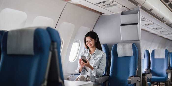 Businesswoman enjoying summer travel vacation on a passenger plane. Concept of work life balance during flight.