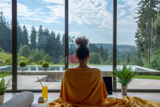 American African woman working with laptop at luxury home.