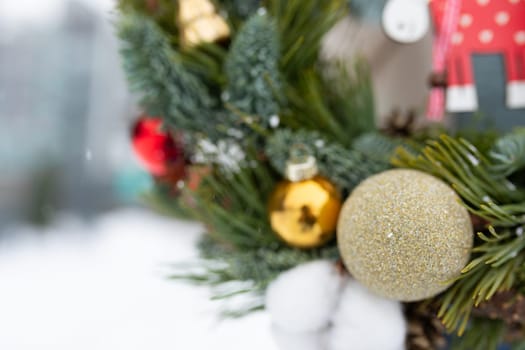 A close-up view of a traditional Christmas wreath adorned with colorful ornaments. The wreath is prominently displayed, showcasing its festive decorations.