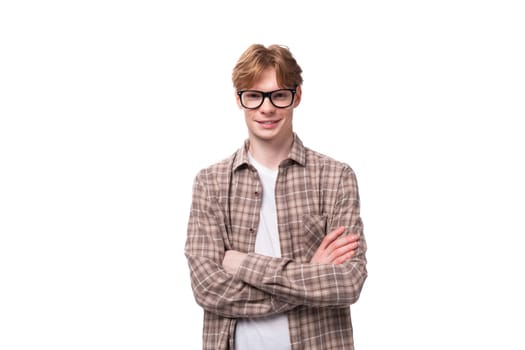 young handsome man with red golden hair wears eyeglasses.