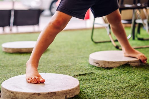 Boy acrobatic movements, standing on hand feet wide steps, feel free to be yourself in any place.