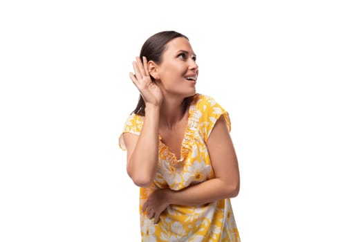 close-up portrait of a young happy friendly caucasian woman wearing a yellow summer t-shirt.