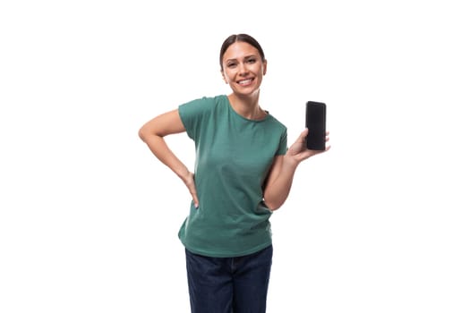 young black-haired woman dressed in a basic t-shirt holding a smartphone.