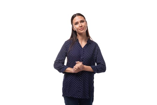 young european slim brunette woman in blue clothes looks confident on a white background.