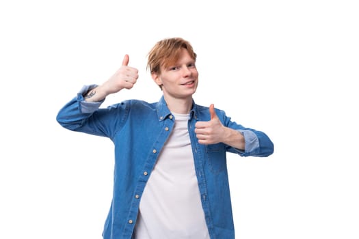 young charming caucasian man with short red hair is wearing a blue shirt.