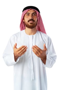 Young Arab man in traditional clothing praying isolated on white background