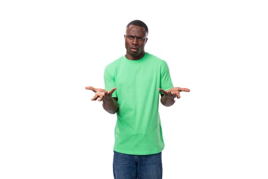 young american man in casual t-shirt thinking over white background.