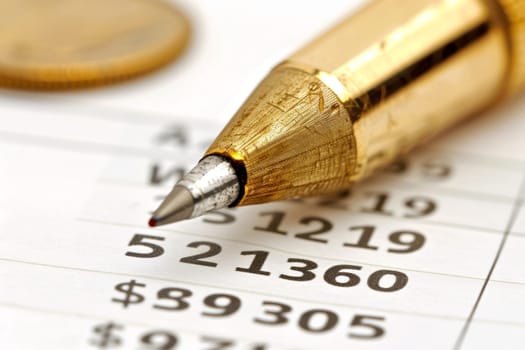 A close-up view of a golden pen nib resting on a sheet of financial figures, highlighting the precision and attention to detail required in accounting and financial management