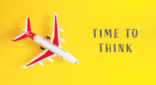 A small airplane is on a yellow background with the words Time to Think written below it