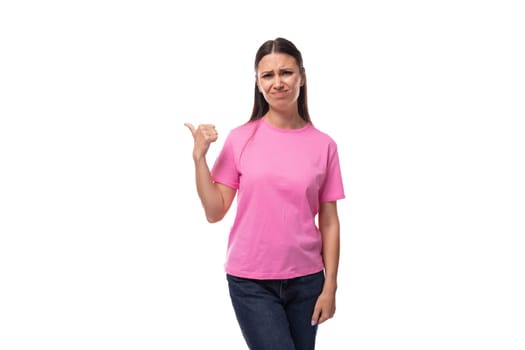 young positive good-looking woman with black hair is wearing a pink t-shirt holding her hand up.