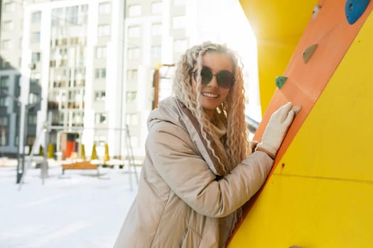 A woman wearing sunglasses is casually leaning against a vibrant yellow surfboard. She appears relaxed and confident in her stance, possibly enjoying a break from surfing.