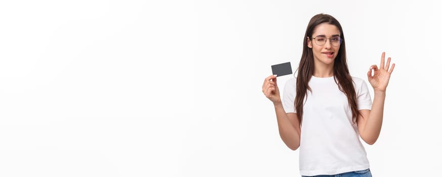 Got everything under control. Good-looking carefree, calm woman assure you all good, no problem cause she have credit card, wink and bite lip encourage all ok, white background.