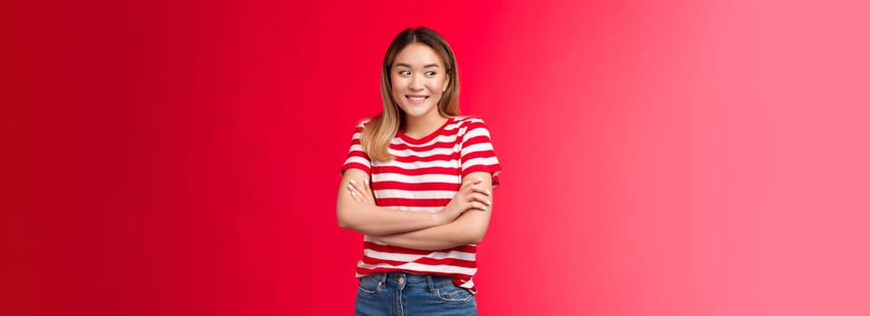 Silly cute pretty asian blond girl look away shy flirty smiling, cross arms chest modest relaxed pose, girlfriend meeting boyfriend best friends blushing lovely, stand red background carefree.