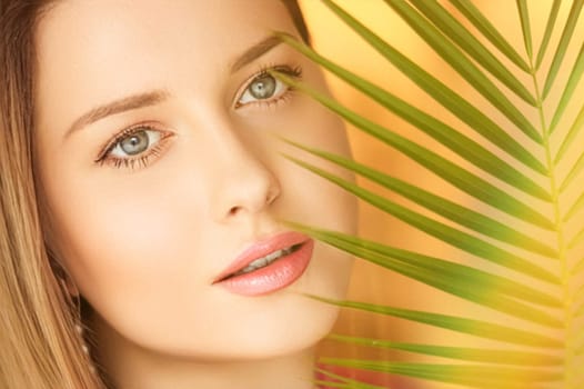 Summer beauty, makeup and skincare, face portrait of beautiful woman with tropical palm tree leaf, natural makeup for cosmetics and fashion look idea