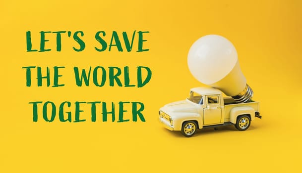 A white truck with a light bulb on top of it. The words Let's save the world together are written below the truck