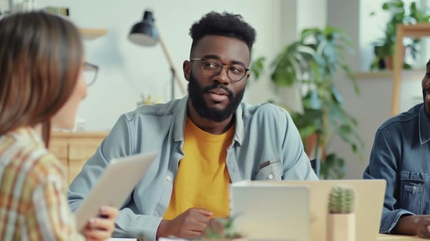 Modern black young man, business people discussing a new project together sitting at the desk in an office, african colleagues having a conversation at a meeting