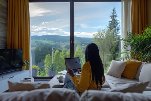 American African woman working with laptop at luxury home.