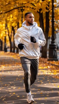 A fit, athletic man jogs through a lush, autumnal forest, surrounded by the warm, golden hues of the changing leaves