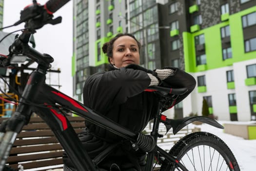 Young pretty woman sat down to rest while cycling.