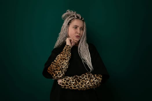 A mature woman with grey hair is shown wearing a stylish leopard print sleeve. She stands confidently as she showcases her fashion-forward choice of clothing.