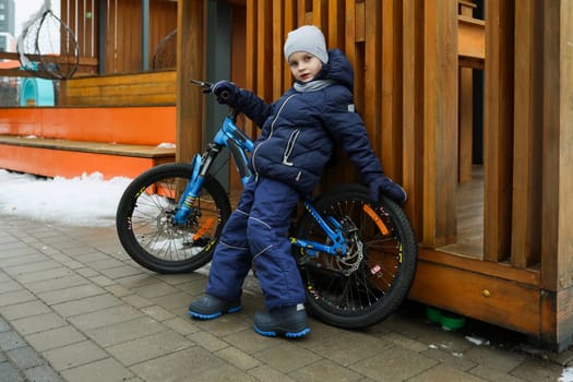 Child boy likes to spend time riding a bike.