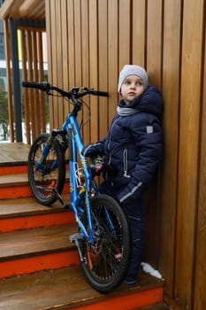 Lifestyle concept, boy riding a bike in winter weather.