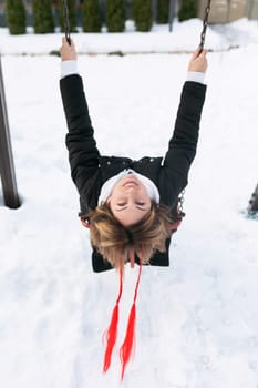 European woman having fun and fooling around outdoors in winter.