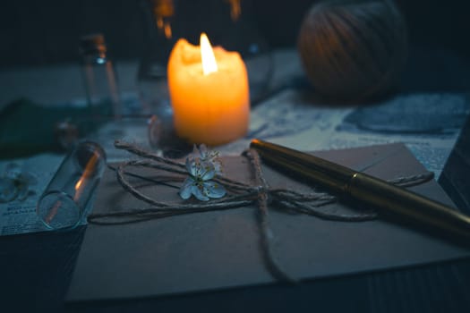 Mystical still life in vintage style with empty flasks, burning candles, letters and newspaper clippings. High quality photo