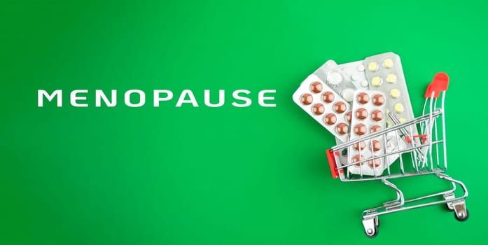 A shopping cart full of medicine for menopause. The cart is on a green background