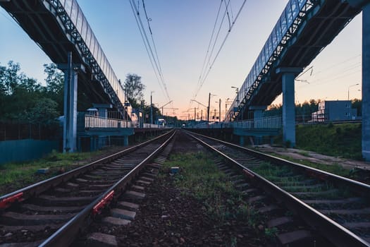 A beautiful railway station in the rays of a colorful sunset. Taking a picture using a wide-angle lens. High quality photo