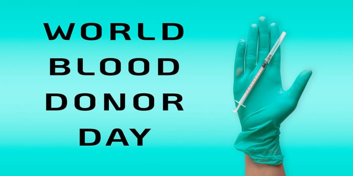 A hand holding a syringe with the words World Blood Donor Day written below it. The image conveys the importance of donating blood and the impact it can have on saving lives