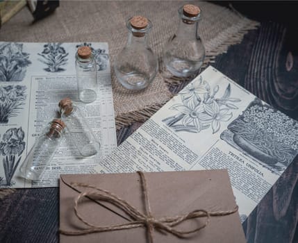 Mystical still life in vintage style with empty flasks, letters and newspaper clippings. High quality photo