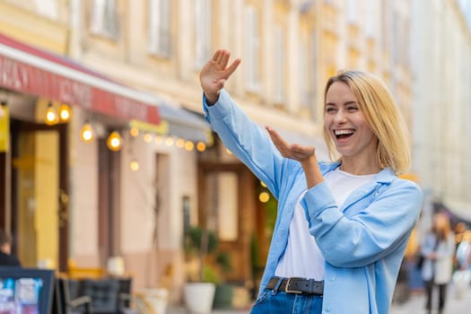 Cheerful rich happy woman showing wasting throwing money around hand gesture, more tips earnings, big profit, win lottery, share, celebrate outdoors. Young lady female traveler standing on city street