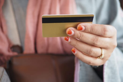 women hand holding credit card and using smart phone shopping online.