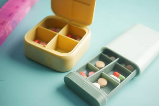 close up of medical pills in a pill box on table .