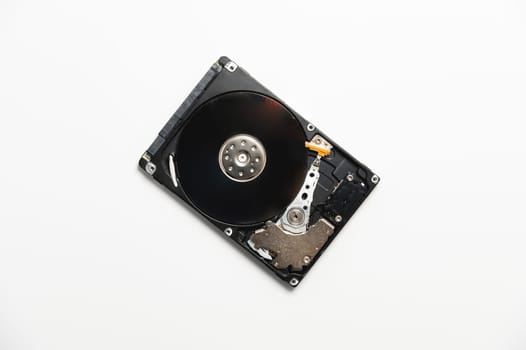 Hard drive from a PC disassembled on a white background. Data recovery concept.