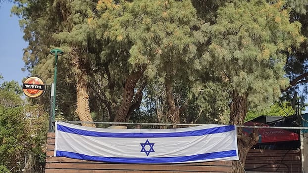 May 22, 2024 Beer Sheva Negev Israel, Israeli flag in the pub, Goldstar beer bar, view from the street. High quality photo