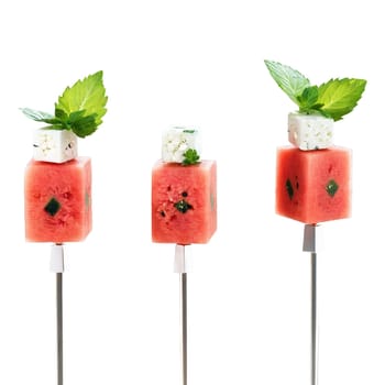 Watermelon and feta skewers with watermelon cubes feta cheese and mint leaves on clear skewers. close-up food, isolated on transparent background