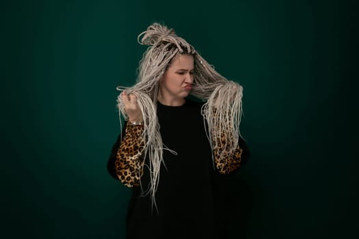 A woman with flowing long hair is standing confidently in a leopard print jacket. Her stylish outfit exudes a bold and fashionable aura.