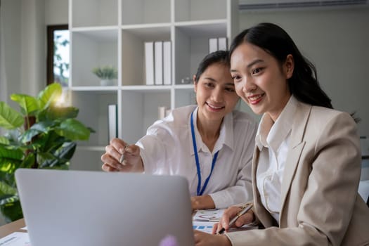 Team businesswomen discussing financial reports in office.