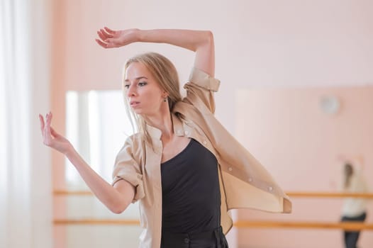 Caucasian woman dancing contemporary in ballet class. Rehearsal