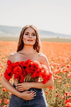 Woman poppies field. portrait of a happy woman with long hair in a poppy field and enjoying the beauty of nature in a warm summer day